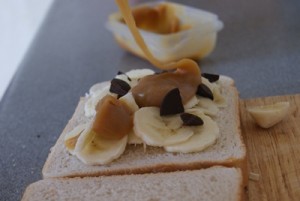 toffee sauce being drizzeled on the banana and chocolate