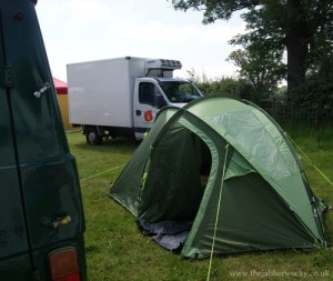 A green tent pitched behind our van, with a refrigerated truck, whose engine was running all night, right behind it.