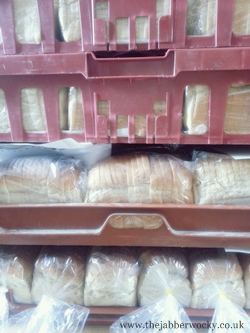 Bread stacked in red bakery crates