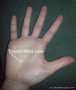 A hand with the "toastie sales line" highlighted