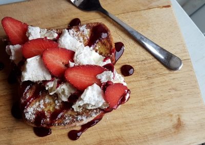 A piece of french toast with strawberries.